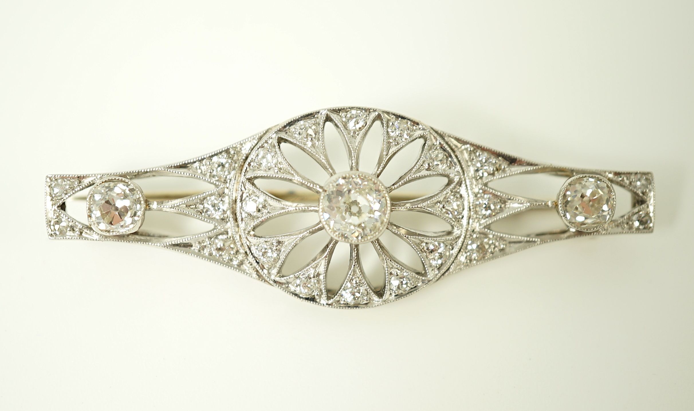 A 1920's pierced white gold and diamond cluster set brooch